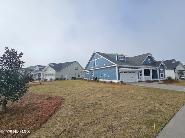 view of front of house with driveway, a residential view, and a front lawn