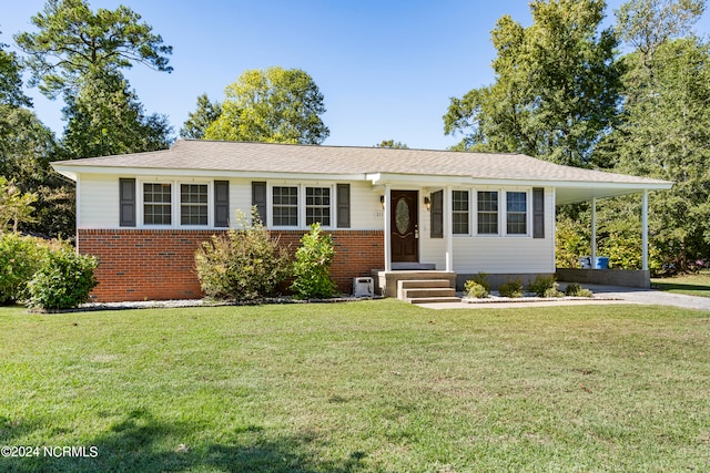 ranch-style house with a carport and a front yard