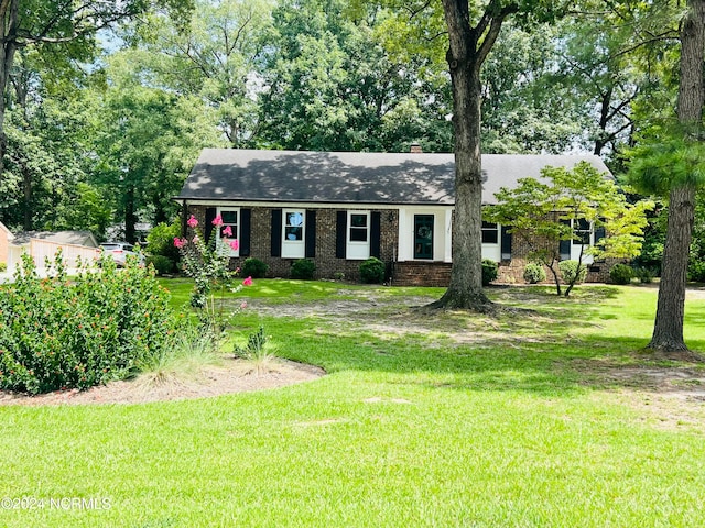 ranch-style home with a front lawn