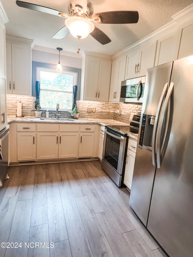 kitchen featuring light hardwood / wood-style flooring, white cabinets, appliances with stainless steel finishes, and sink