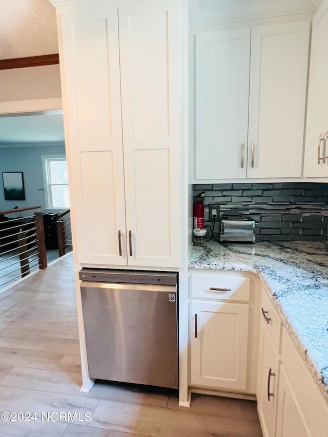 kitchen with ornamental molding, tasteful backsplash, light hardwood / wood-style flooring, white cabinetry, and light stone countertops