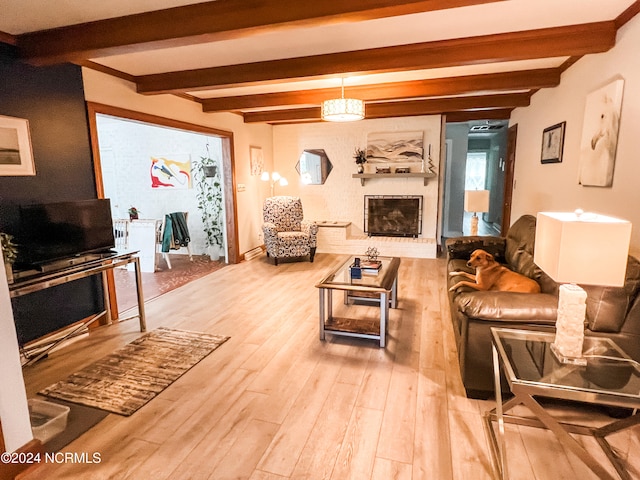 living room featuring beamed ceiling and hardwood / wood-style floors