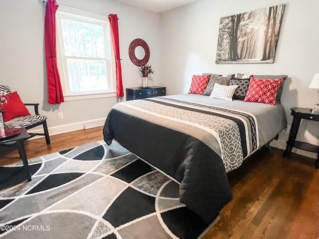 bedroom with wood finished floors and baseboards