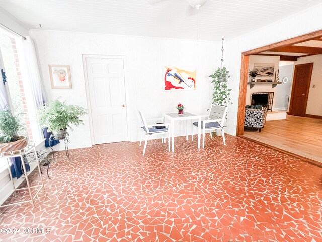 unfurnished dining area featuring wood-type flooring and beamed ceiling