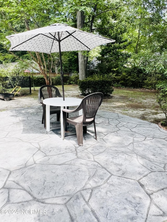 view of patio with fence and outdoor dining area