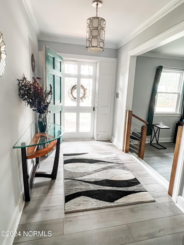 entryway featuring wood-type flooring and ornamental molding