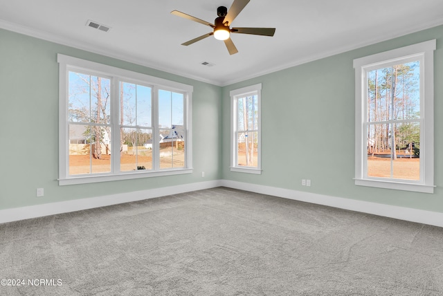 unfurnished room with crown molding, a ceiling fan, visible vents, and carpet floors