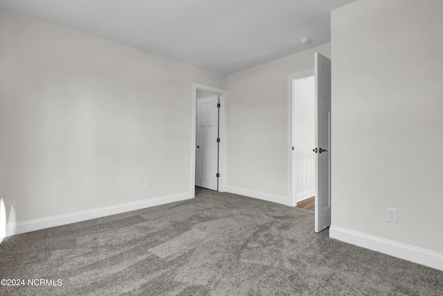 unfurnished bedroom featuring baseboards and carpet floors