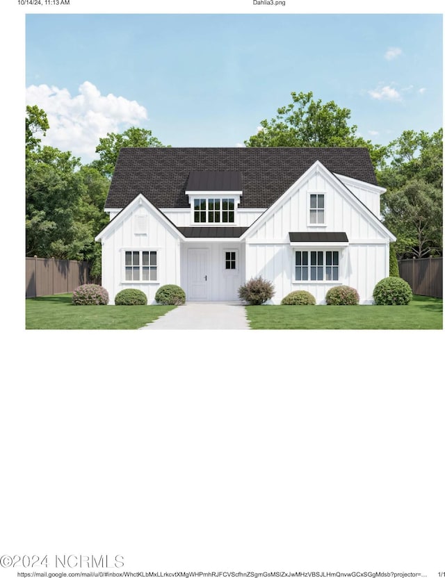 view of front of home featuring a front yard, fence, and board and batten siding