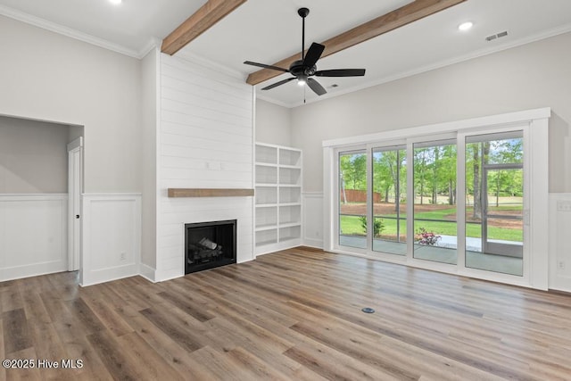 233 Hampton Ct, Hampstead, NC 28443 - unfurnished living room with ornamental molding, a decorative wall, a ceiling fan, and light wood-style floors