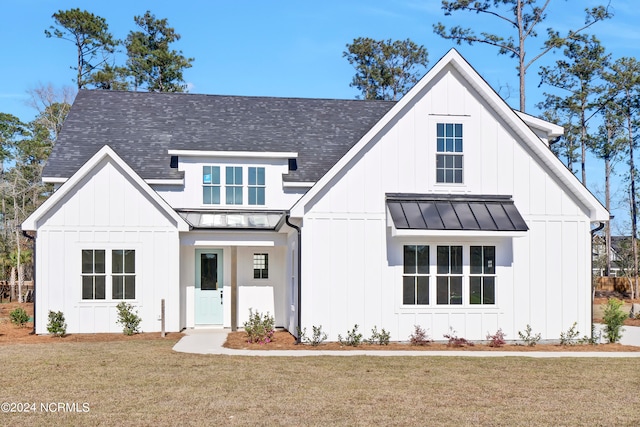 modern farmhouse style home with a front yard