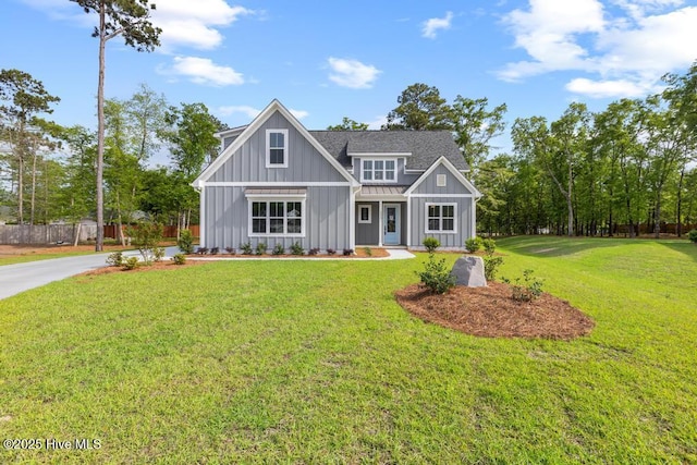 233 Hampton Ct, Hampstead, NC 28443 - view of front facade with a front lawn, fence, and board and batten siding