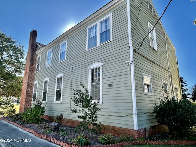 view of side of home featuring crawl space