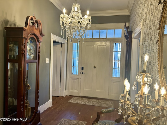 entrance foyer featuring baseboards, dark wood-style flooring, an inviting chandelier, and crown molding