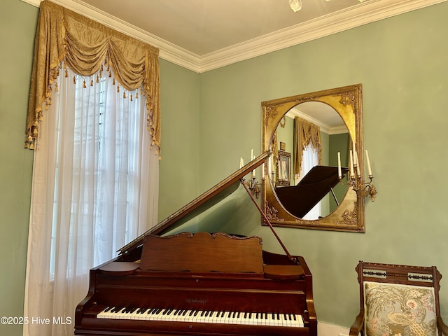 sitting room with crown molding and stairs