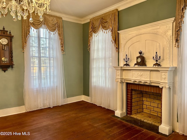 living area with dark wood-style floors, a brick fireplace, ornamental molding, and baseboards