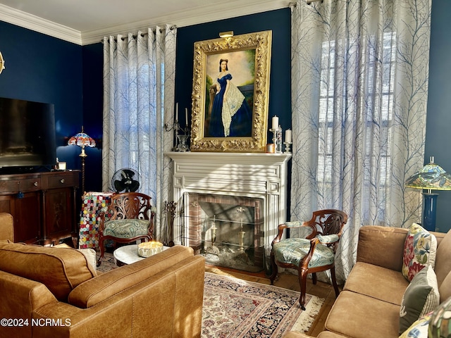 living area with a fireplace and crown molding