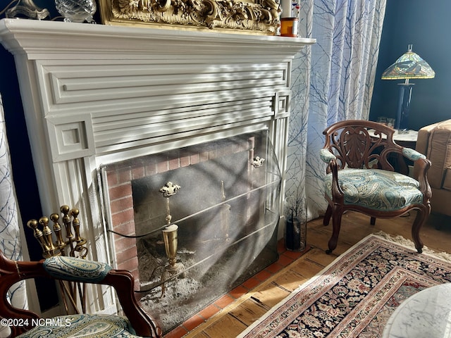 sitting room featuring a fireplace and wood finished floors