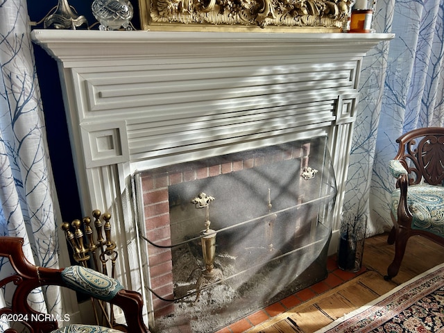 interior details featuring a fireplace and wood finished floors