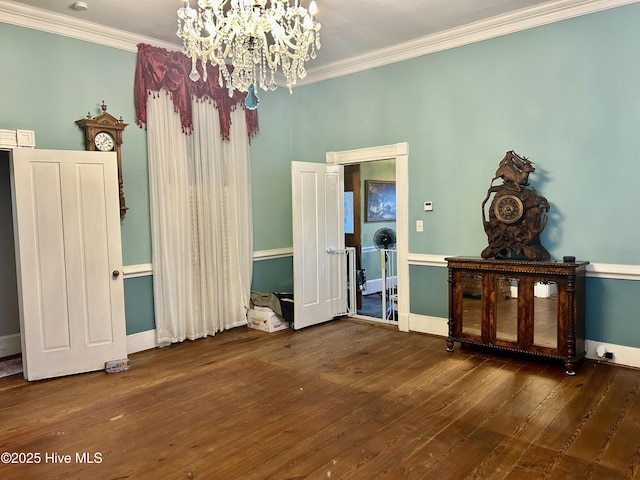 unfurnished dining area featuring dark wood-style floors, a chandelier, and crown molding