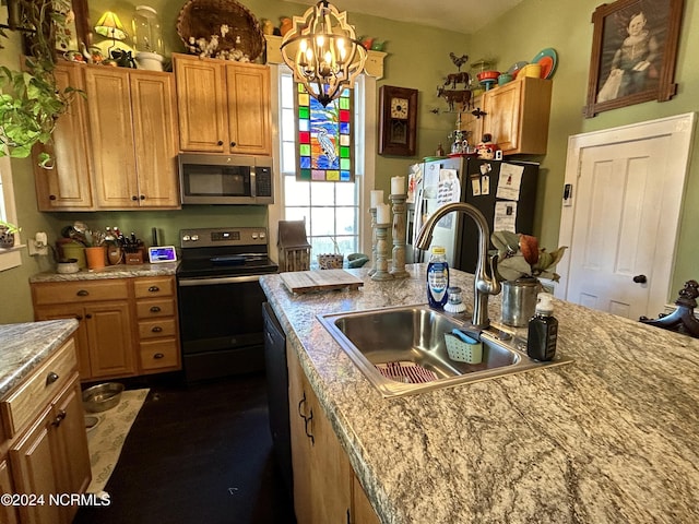 kitchen featuring pendant lighting, a notable chandelier, appliances with stainless steel finishes, brown cabinetry, and a sink