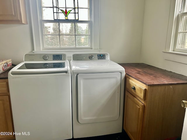 laundry area with cabinet space and separate washer and dryer