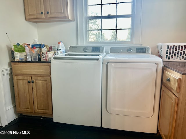 washroom with cabinet space and washing machine and clothes dryer