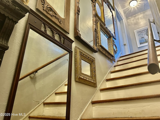 staircase with a textured wall