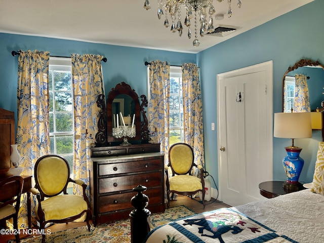 bedroom with visible vents and a notable chandelier