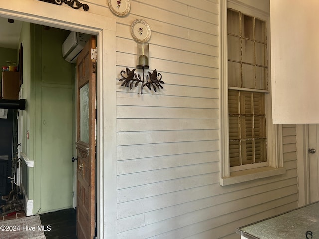 entrance to property featuring a wall unit AC