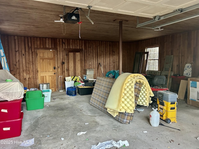 garage featuring wood walls and a garage door opener