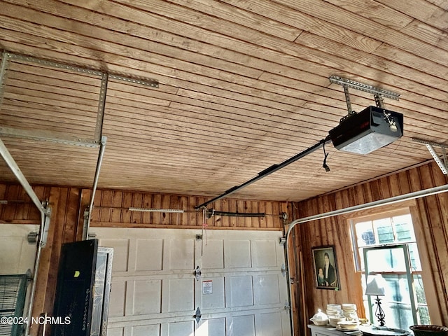 garage with wooden walls, wooden ceiling, and a garage door opener