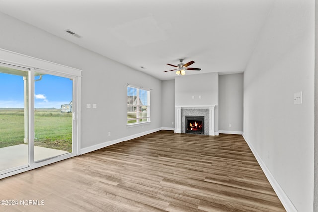 unfurnished living room featuring light hardwood / wood-style flooring and ceiling fan