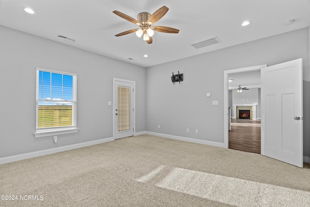 unfurnished bedroom with ceiling fan and carpet floors