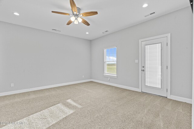 unfurnished bedroom with ceiling fan, a closet, carpet flooring, and a walk in closet