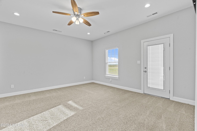 spare room featuring ceiling fan and carpet flooring