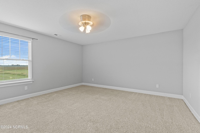 empty room with ceiling fan and carpet floors