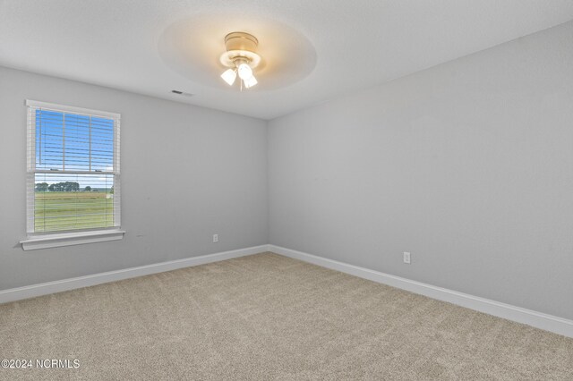 unfurnished bedroom featuring light carpet, a closet, and ceiling fan