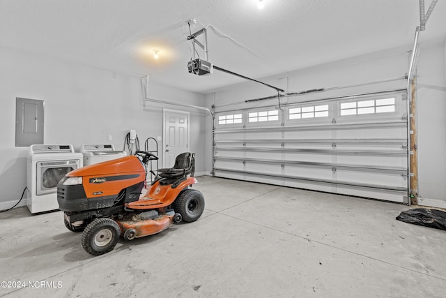 garage featuring a garage door opener, separate washer and dryer, and electric panel