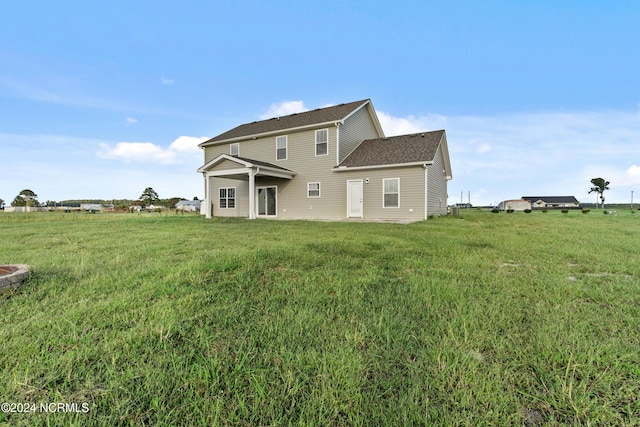 rear view of house with a lawn