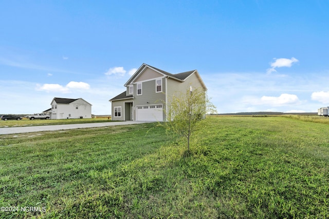 view of front of property with a garage and a front yard