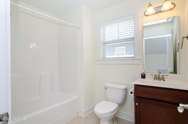 bathroom featuring vanity, tile patterned floors, shower / bath combination, toilet, and baseboards