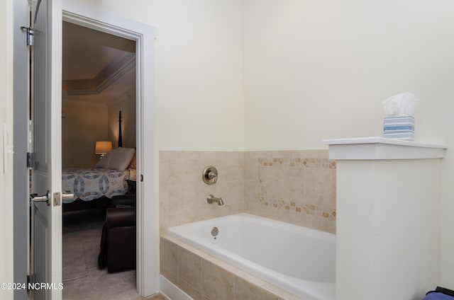 bathroom featuring ornamental molding, a bath, and ensuite bathroom