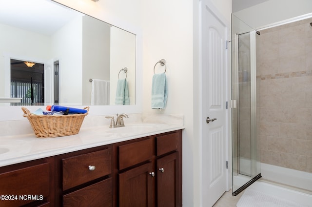 bathroom featuring vanity and an enclosed shower