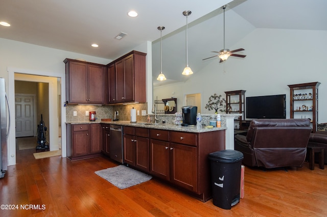 kitchen featuring light stone counters, decorative backsplash, dark hardwood / wood-style floors, high vaulted ceiling, and appliances with stainless steel finishes