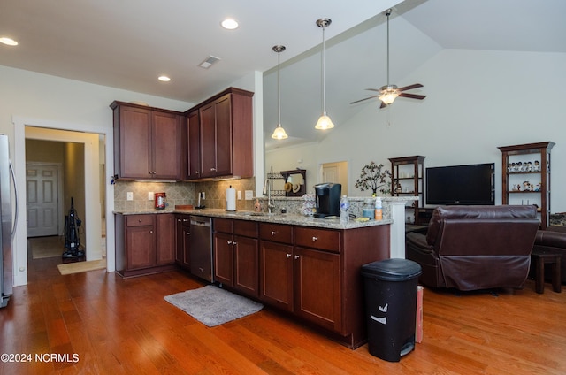kitchen with a peninsula, ceiling fan, appliances with stainless steel finishes, and wood finished floors