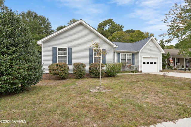 ranch-style home featuring a garage and a front lawn