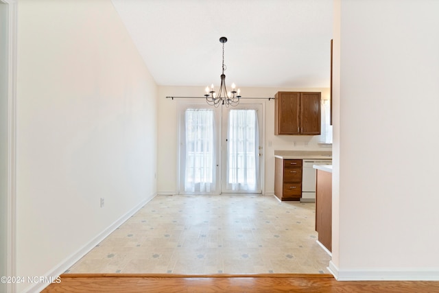 kitchen featuring an inviting chandelier, light hardwood / wood-style flooring, dishwasher, and hanging light fixtures