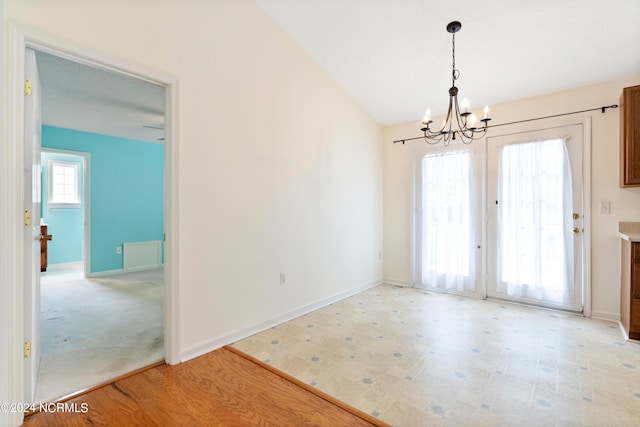 interior space with lofted ceiling, light hardwood / wood-style flooring, and a notable chandelier