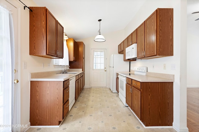 kitchen with lofted ceiling, sink, decorative light fixtures, white appliances, and ceiling fan